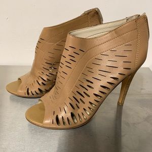 Woman’s tan peep-toe bootie